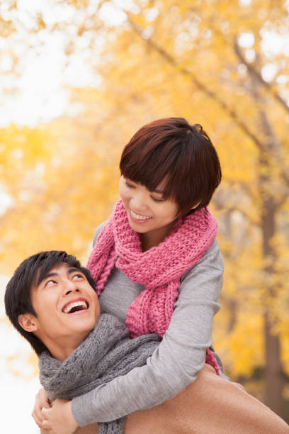 istock Chinese man giving girlfriend piggy back ride 1082694444