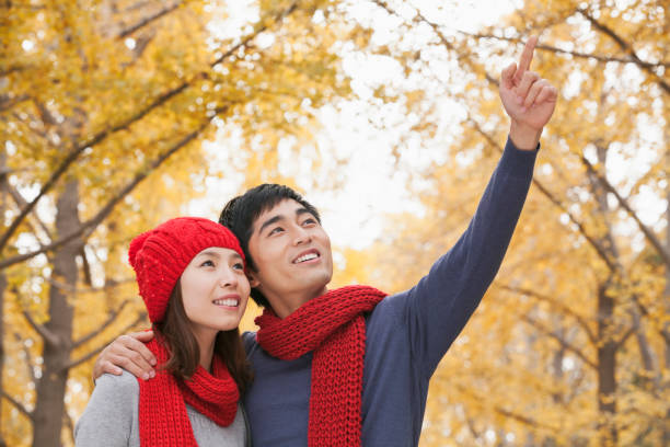 istock Chinese man showing something to girlfriend 1082694740