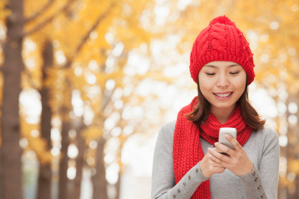 istock Chinese woman text messaging on cell phone 1082694748