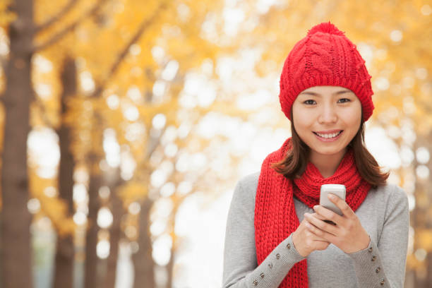 istock Chinese woman text messaging on cell phone 1082694784