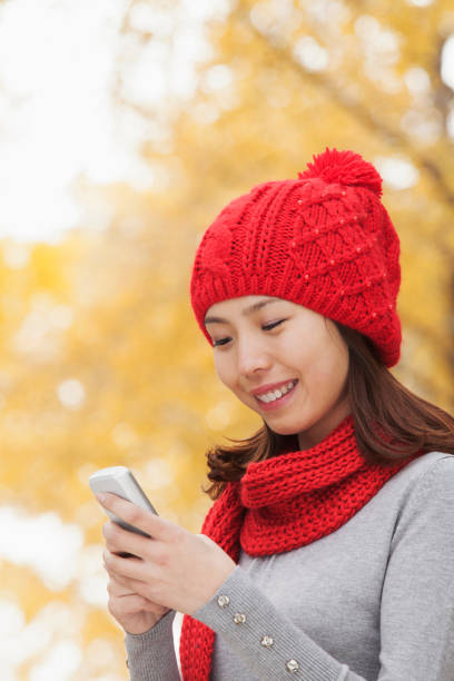 istock Chinese woman text messaging on cell phone 1082694840