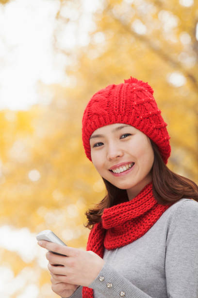 istock Chinese woman text messaging on cell phone 1082694924