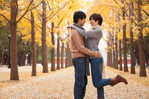 Chinese couple hugging in park