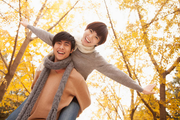 istock Chinese man giving girlfriend piggy back ride 1082696118