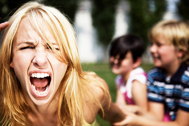 a mom going crazy while playing with her children - fury stok fotoğraflar ve resimler