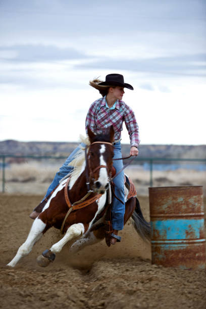 ritratto di cowgirl salto del barile al tramonto - photography teenagers only vertical teenager foto e immagini stock