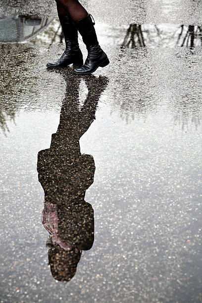 istock Reflection of Young Woman in Puddle 108269960