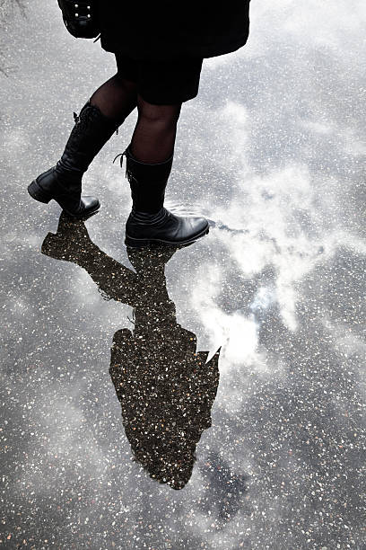 istock Young Woman Walking Through Puddle on Overcast Day 108269964
