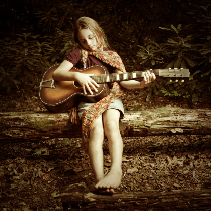 indie girl playing the guitar