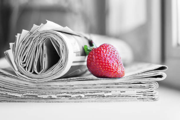 Newspapers and strawberry stock photo