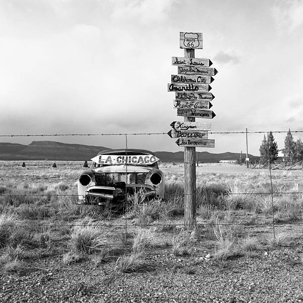 coche viejo abandonado estadounidense en el desierto por la route 66 - arrow sign road sign fence fotografías e imágenes de stock