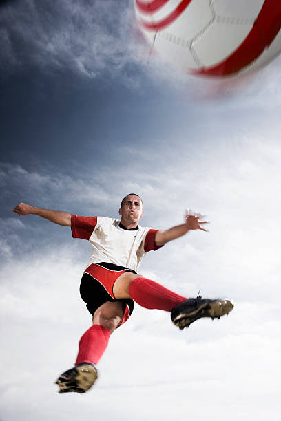 istock Soccer Player Kicking Ball in Mid Air 108270202