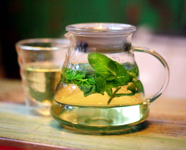 istock Bright photo background macro big tea mint in a teapot 1082703128