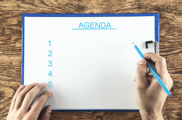 istock Male hands with business agenda list. 1082703916