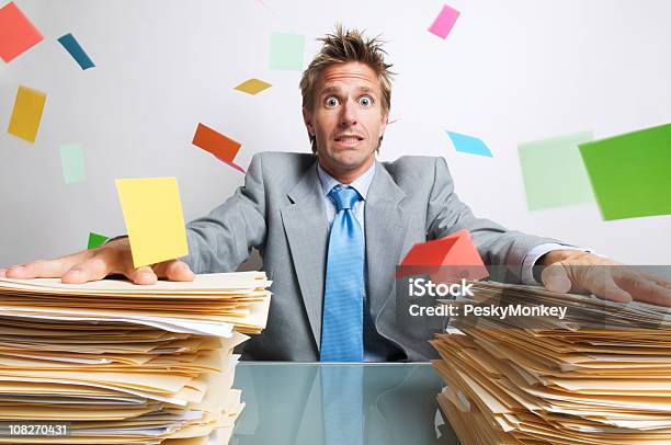 Stressed Businessman Office Worker Trying To Hold Down Chaos Stock Photo - Download Image Now