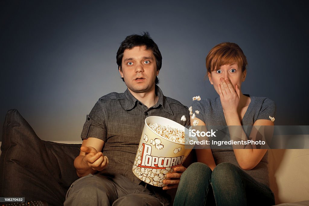 Shocked couple Young couple watches TV. Shock Stock Photo