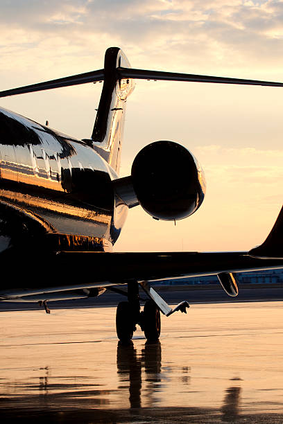 Backside of Private Jet on Tarmac at Dusk stock photo
