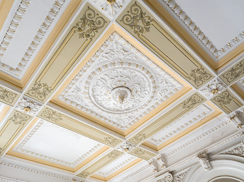 Stucco ceiling and wall. Molding, cornice. Old plaster architectural elements of the interior