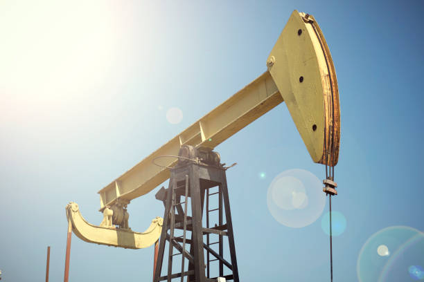 istock Oil pumps are working in the blue sky background 1082707330