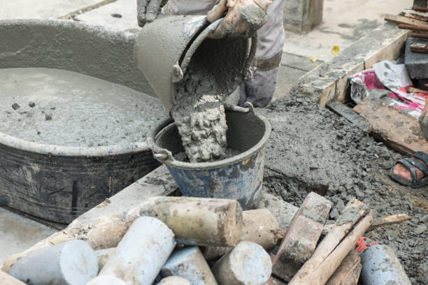 istock Worker pouring cement mix concrete in bucket at a construction site. 1082709884