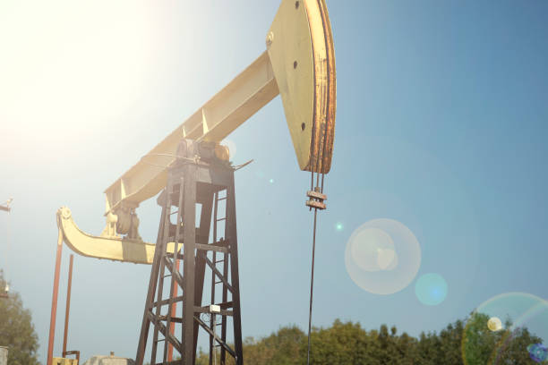 istock Oil pumps are working in the blue sky background 1082710428