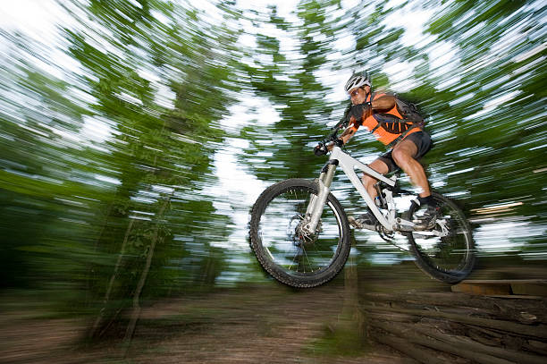 istock Mountain bikers at the downhill with jump 108271088