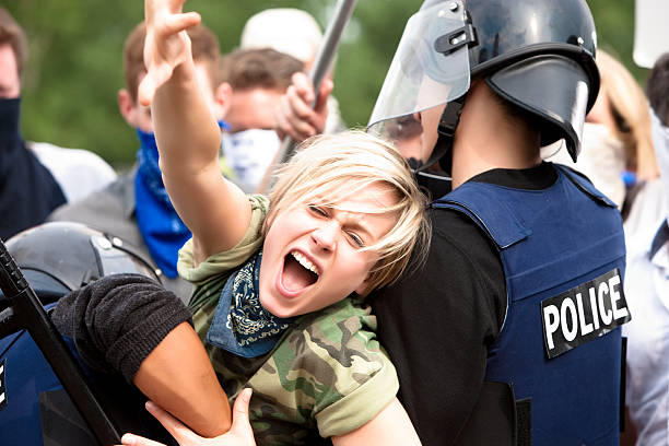Protestor Trying to Get Through Police Barricade  strike protest action stock pictures, royalty-free photos & images