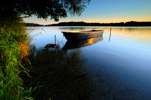 Lake with fishing boat at sunset