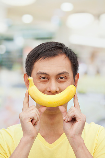 Chinese man holding banana