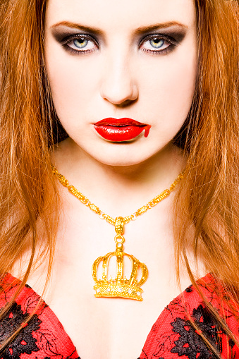 Beauty queen. Woman with crown on head and diamond necklace on her neck with positive facial expression looking at you camera posing isolated white background. Multicultural Caucasian Irish model