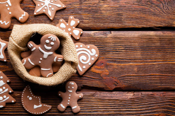 Gingerbread cookies in jute bag on wooden table as Christmas symbols stock photo