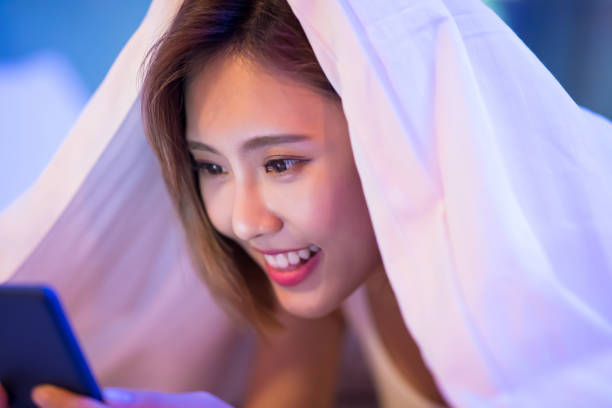 istock woman use phone on bed 1082717648