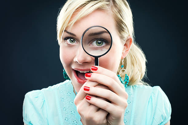 istock Woman looking through a magnifying glass 108271828