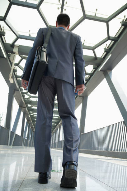istock Chinese businessman walking in tunnel 1082720596