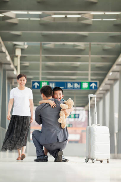 istock Chinese businessman greeting son on train platform 1082720750