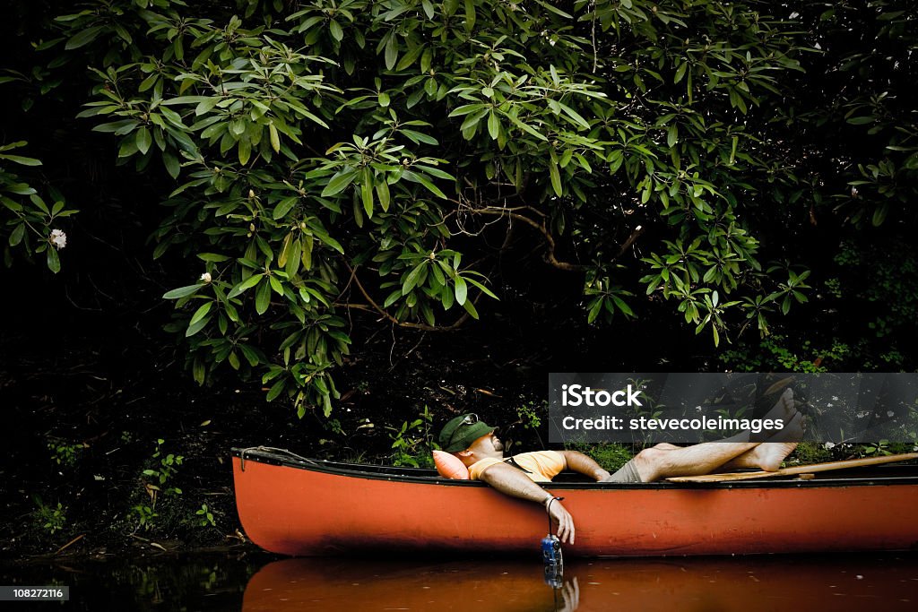 Man Taking Nap in Canoe  Sleeping Stock Photo