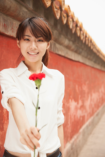 Chinese woman holding flower