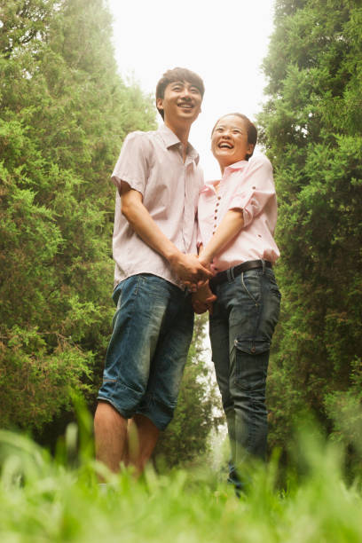 istock Chinese couple holding hands in park 1082721936