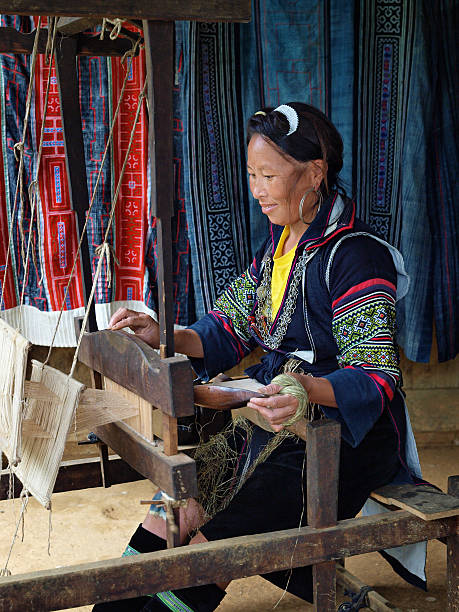Traditional Lady Operating Weaving Loom An woman of the Black H'mong Hilltribe (North Vietnam) dressed in traditional ethnic costume operating a weaving loom. central highlands vietnam photos stock pictures, royalty-free photos & images