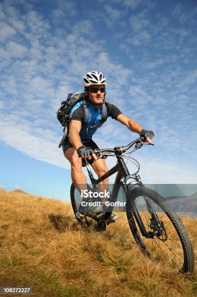 Man Mountain Biking In Mountains Stock Photo - Download Image Now - Mountain Biking, Adult, Adults Only