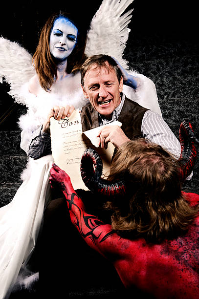 istock man ripping apart contract with devil and angel 108272249