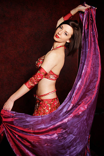 istock Beautiful brunette female with veil belly dancing 108272337