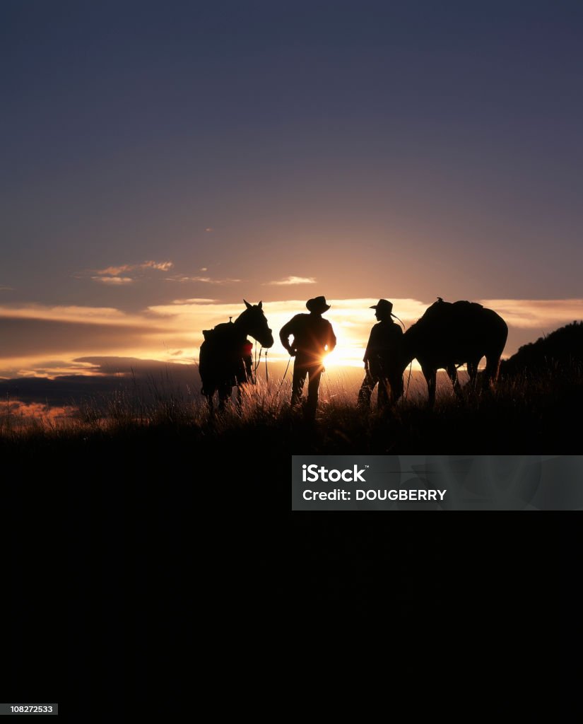Cowboys au coucher du soleil - Photo de Cow-boy libre de droits
