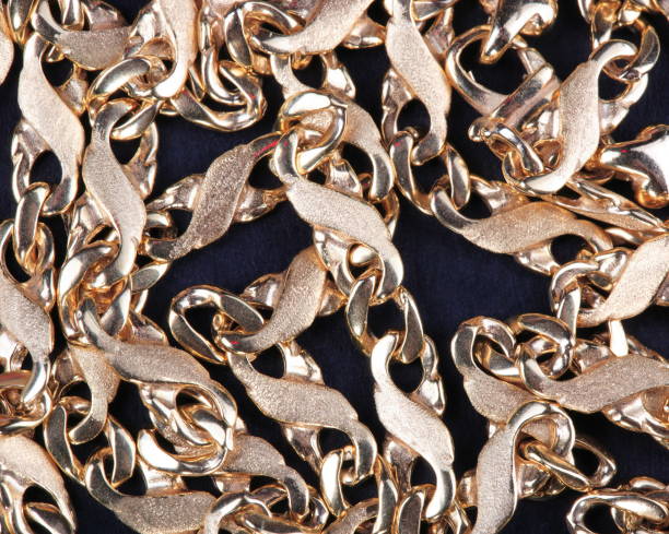 istock yellow Gold Chain on black fabric 1082726370
