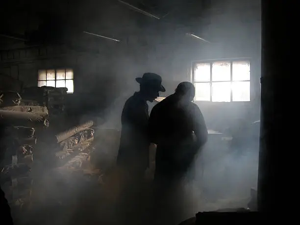 Photo of Silhouette of Men in Smoke