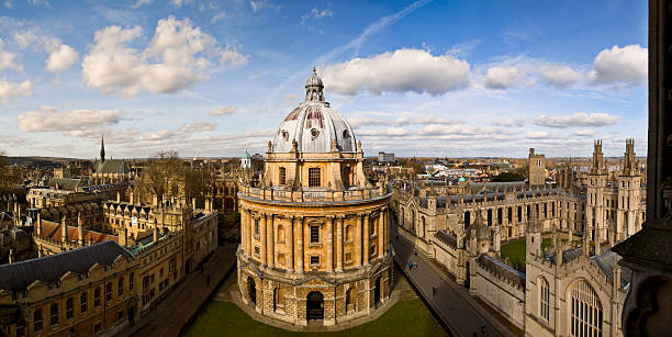 Panoramic photo of the Oxford skyline and Radcliffe Camera Panoramic view of Oxford in England oxford university photos stock pictures, royalty-free photos & images