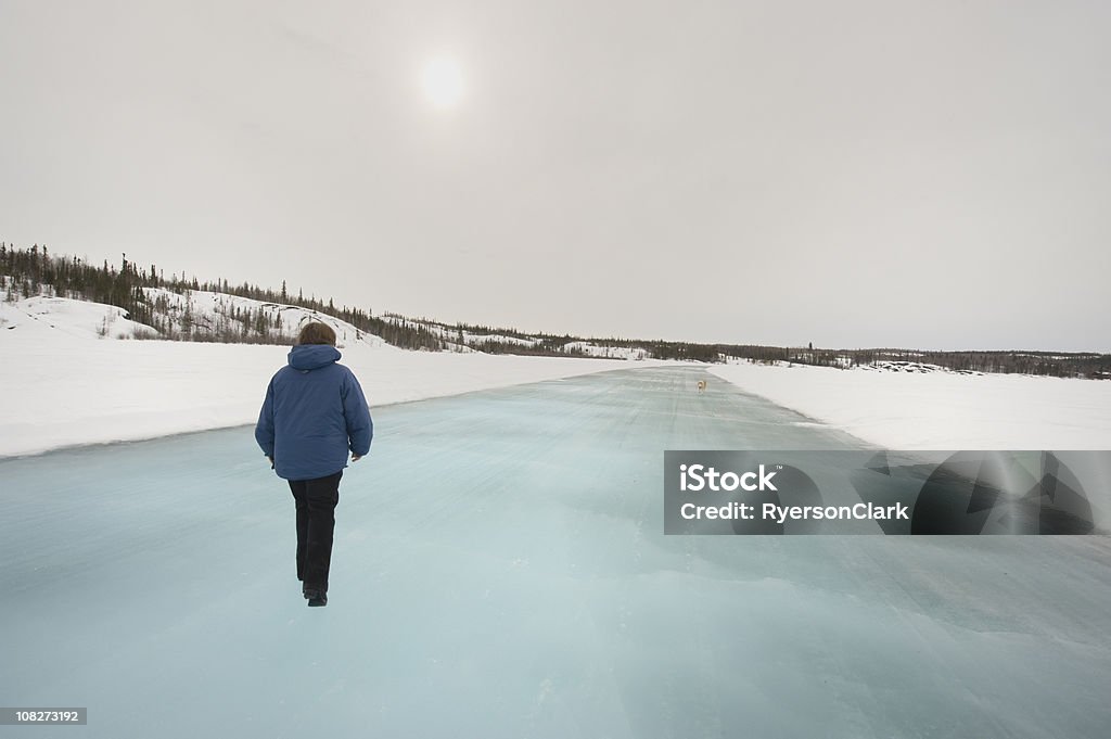 Ice Road, Yellowknife. A woman walks along an ice road under a weak sun in Canada's Northwest Territories.  Click to view similar images.
[url=file_closeup.php?id=9207015][img]file_thumbview_approve.php?size=1&id=9207015[/img][/url] Yellowknife Stock Photo