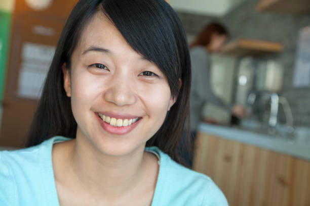 istock Chinese businesswoman smiling in office kitchen 1082732202