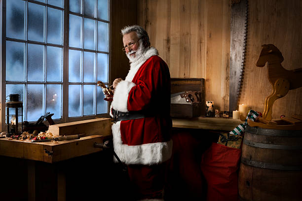 Antique Toy Making Shop with Santa Claus on Winter Night stock photo