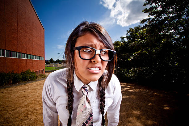 Nerdy Hispanic Girl Outside of School Looking Worried stock photo